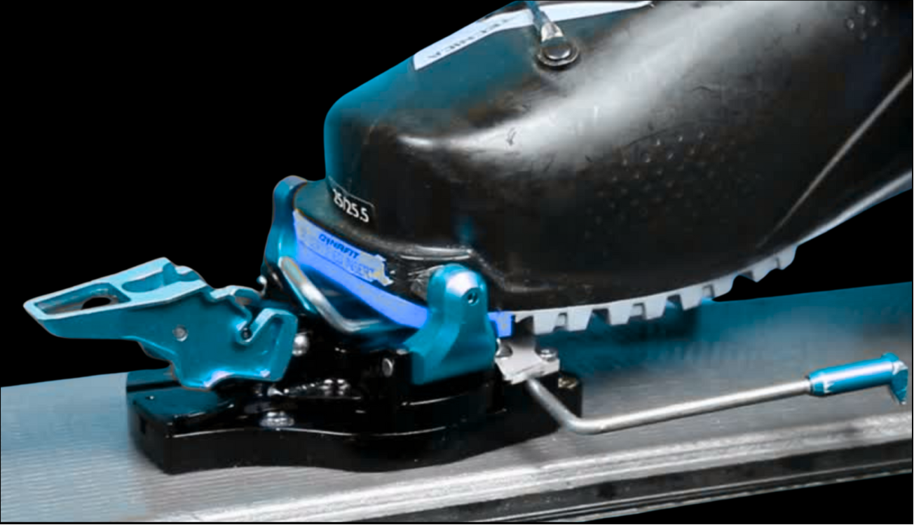 Close-up of a ski binding mechanism with blue and black components on a clear background